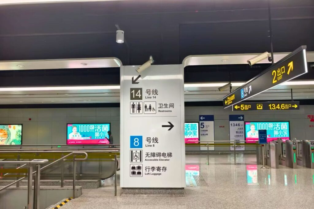 Panneaux directionnels du métro chinois avec lignes colorées et indications de direction